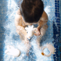 Picture of a child playing with the Oli&Carol aquatic albino bath toys in a swimming pool.