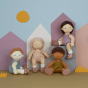 The collection of four new 2023 Dinkum Dolls, Bitsy, Button, Pea and Petal. They are pictured against a multi coloured purple background with cut out house, sun and grass shapes 