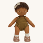 Olli Ella Button poseable, soft bodied, curly haired, Dinkum Doll wearing a cream coloured hair bow standing up pictured on a plain coloured background 