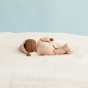 Olli Ella childrens eco-friendly soft dozy dinkum doll in the daisy print on a white blanket on a blue background