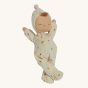 Olli Ella Lullaby Dozy Dinkum Doll - Lyra, a poseable baby doll with white skin, a tuft of light brown hair, and a non-removable buttercream soft velvet onesie with golden embroidered stars.