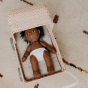 Close up of an Olli Ella dinkum doll laying in an olli ella strolley on top of the seafoam strolley mattress 