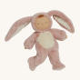 Olli Ella Cozy Dinkums Doll - Bunny Flopsy. A soft body doll, in a fluffy pink fur and a fluffy white belly none removable onesie. Bunny Flopsy has their eyes closed, long fluffy pink ears attatched to the hood of their onesie, and a little brown tuft of 