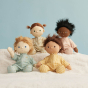 4 Olli Ella dinkum dolls sat on a white blanket wearing the daydream collection doll pyjamas