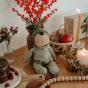 Olli Ella limited edition dozy dinkum pie doll leaned up against a brown vase on a festive table
