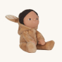 A side view of Olli Ella Dinky Dinkum Doll Fluffles - Bucky Bunny, wearing a fluffy light brown all in one with the hood down which has fluffy bunny ears, on a cream background