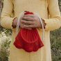Image of child holding the Fantastic Fruit Tubbles Stones within a red, mesh draw string bag