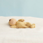 Olli Ella eco-friendly soft baby dinkum doll laying on a white blanket
