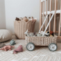 Close up of the Olli Ella handmade rattan toy trolley, filled with Olli Ella soft toys