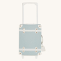 Olli Ella Kids See-Ya Suitcase in a steel blue colour with handle extended pictured on a plain background