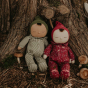 Olli Ella pudding and pie dozy dinkum dolls leaning up against a large tree stump