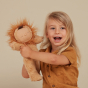 Child holding up the Olli Ella Lion Pip Cozy Dinkum Doll pictured on a plain white background