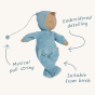 Olli Ella Lullaby Dozy Dinkum Doll - Leo is a baby doll with white skin, a tuft of yellow hair, and a non-removable baby blue soft velvet onesie with silver embroidered stars. Infographic.