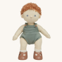 Olli Ella Pea poseable, soft bodied, red curly haired, Dinkum Doll standing up pictured on a plain coloured background 