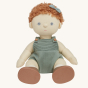 Olli Ella Pea poseable, soft bodied, red curly haired, Dinkum Doll sitting down pictured on a plain coloured background 