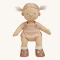 Olli Ella Pea poseable, soft bodied Dinkum Doll standing up with their hair tied in bunches at the sides of their head pictured on a plain coloured background 