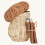 An Olli Ella Porcini mushroom shaped Basket with wooden twig colouring pencils next to it pictured on a plain background