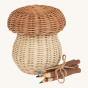An Olli Ella Porcini mushroom shaped Basket with wooden twig colouring pencils next to it pictured on a plain background