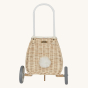A view from the the back of the Olli Ella Rattan Bunny Luggy with Lining – Pansy Floral. A beautifully woven pull along Luggy basket with cream cotton lining with a vintage pansy floral pattern with bunny ears and a white fluffy tail, on a cream backgroun