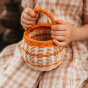 childs hands shown on the olli ella basket