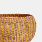 Close up of the Olli Ella plastic free seagrass woven basket in the clay and mustard colour on a white background