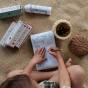 A child colours in the Olli Ella Playpa Children's Colouring Paper Roll Travel Pack  -  Ocean Design in a home setting.
