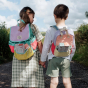 Two children are carrying Olli Ella Playpa Mini Packs in their backpacks.