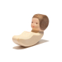 Close up of the baby figure from the Ostheimer plastic-free baby and cradle set on a white background