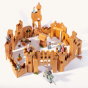 Ostheimer kids wooden castle toy set laid out in a scene on a beige background