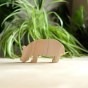 O-WOW eco-friendly maple wood hippo toy on a wooden worktop in front of a green house plant