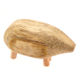 Close up of a Papoose hand carved wooden pebble animal figure on a white background