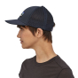 Side profile of a woman wearing the Patagonia adults eco-friendly trucker cap in the navy blue colour
