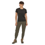Patagonia Women's Happy Hike Studio Pants in Basin Green worn yb woman with short brown hair, dark brown short sleeve top, and hiking boots on a white background