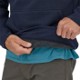 Close up of hands pulling up the Patagonia new navy uprisal hoody showing the warm fleece lining