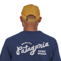Patagonia Line Logo Ridge Stripe Funfarer Cap in Oaks Brown from the back worn by a person wearing a navy top on a white background