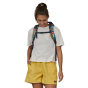 view of the front of a person wearing the Patagonia Atom Tote Pack 20L - Joy / Pitch Blue 