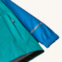 A close up of the pocket, cuffs, arms and reflective strip on the Patagonia Kid's Torrentshell 3 Layer Waterproof Rain Jacket - Vessel Blue