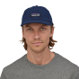 Close up of man wearing the Patagonia eco-friendly classic navy P-6 label trad cap on a white background