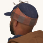 Patagonia Range Earflap Cap - Upriver / Sisu Brown. A man models the back of the cap against a plain background.