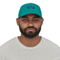 Man stood on a white background wearing the Patagonia eco-friendly airshed cap 