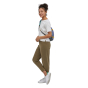 Full body shot of a woman wearing the Patagonia atom sling 8l pack on a white background