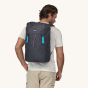 A man wears the Patagonia Fieldsmith Lid Backpack to show the backpack fit.