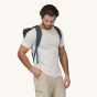 A man wears the Patagonia Fieldsmith Lid Backpack to show the backpack fit. 