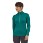 Woman wearing the Patagonia eco-friendly 100% recycled polyester r1 zip neck top on a white background