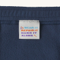 Patagonia Kids Micro-D Fleece Joggers - New Navy on a plain background. View of the 'wear it repair it' tag on the inside of the joggers.