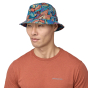 Front view of adult wearing a Patagonia Wavefarer Bucket Hat in a Joy: Pitch Blue pattern 