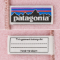 The Patagonia label and name label attatched to the inside seem of a pink Patagonia Little Kids Synchilla Fleece Vest