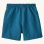 Back of the Patagonia children's blue baggies shorts on a beige background