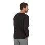 Man stood backwards wearing the eco-friendly Patagonia 73 skyline logo sweatshirt in black on a white background
