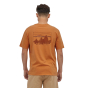 Man stood backwards on a white background wearing the Patagonia organic cotton skyline t-shirt in the cloudberry orange colour